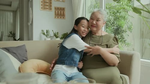 Smiling Girl and Senior Woman Enjoy Family Time