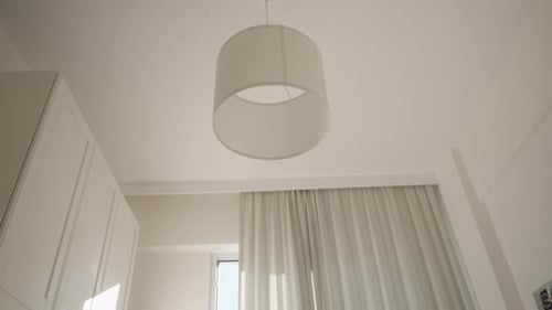 Person Resting in Sunny Bedroom with Feet Visible