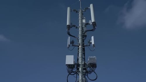 A Cell Tower Stands Tall Against a Clear Blue Sky a Symbol of Modern Communication and Connectivity
