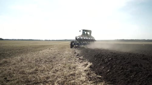 Tractors plowing the field in Ukraine