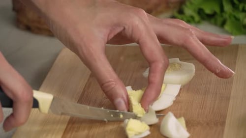 Cutting Hard Boiled Eggs on Wooden Board