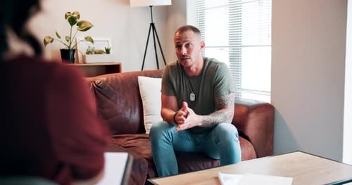 Man Talking on Couch During Therapy Session