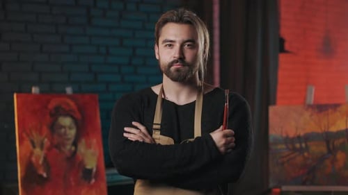 Painter with Neutral Facial Expression Standing at Workshop