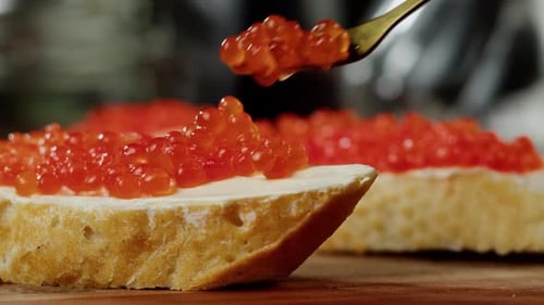 Preparing Red Caviar Sandwich With Fork Close Up