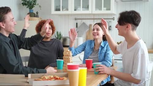 Home Party Cheerful Friends Giving High Five Together Playing in Board Game at Home Happy Diverse