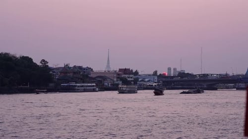 Dusk From the Chao Phraya River Where the Illuminated Boats Circulate Near the Bridge with a Lot of