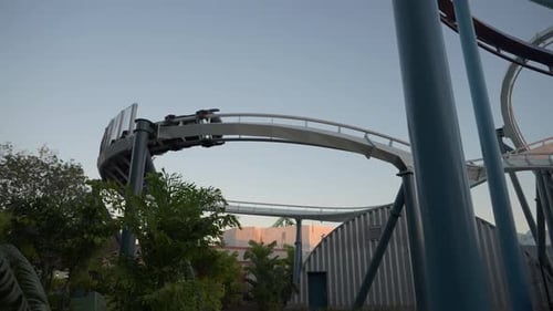 Thrilling Roller Coaster Ride Experience at Amusement Park in the Evening