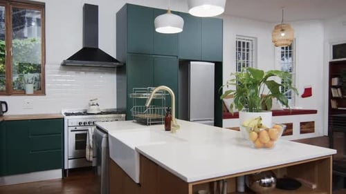 General view of modern kitchen with countertop, cupboards and kitchen equipment, slow motion
