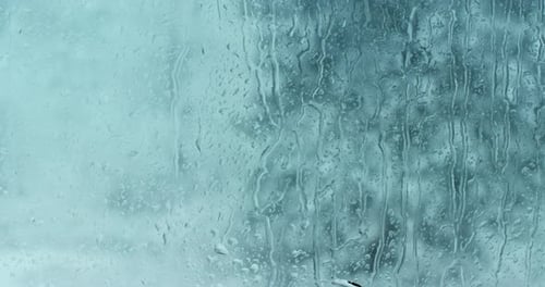 Raindrops Streaming Down a Window