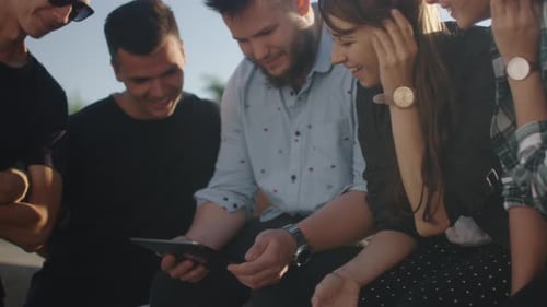 Friends Gathered Together Looking at Tablet Device