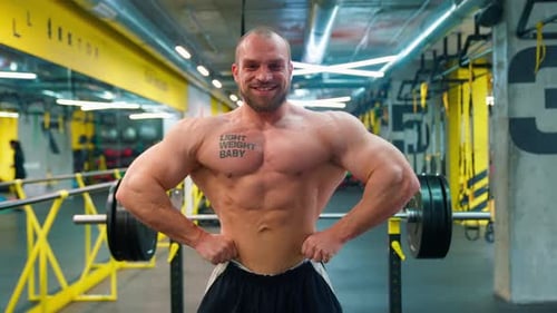 Muscular Man Posing in a Modern Gym