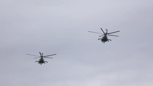 Two Military Helicopters Fly in Sky