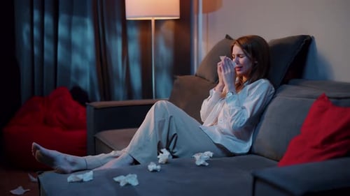 Sad Woman Crying on Sofa at Night