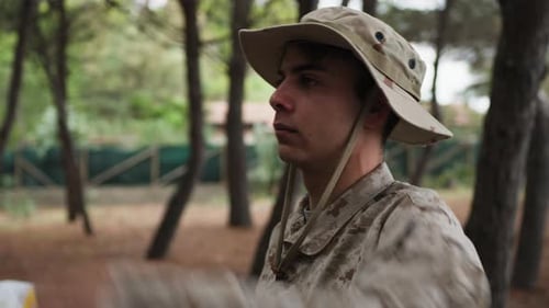 Soldier Stands At Attention Saluting The General In The Woods With Trees