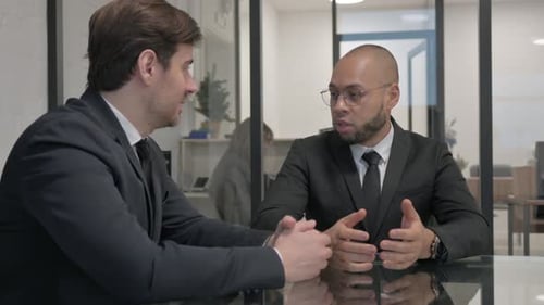 Professional Men in Suits Discuss Business in Office