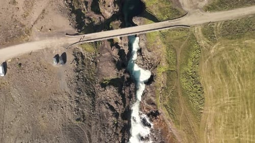 Aerial View Of Mountain River Flowing Through A Canyon In Icelandic Highlands