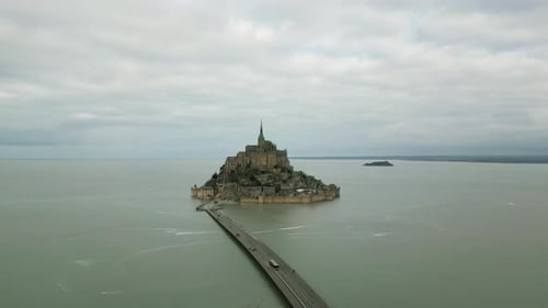 Mont Saint Michel on cloudy day, Normandy in France. Aerial drone panoramic view and sky for copy sp