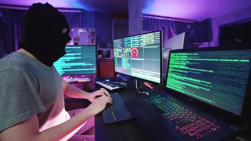 Funny Cyber Hacker Coding on Computer or Man in Mask Hacking Program on Laptop