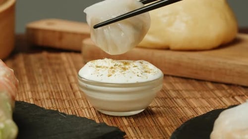 Dipping Dimsun Into White Sauce Closeup Macro Dim Sun Gedza Dumplings Spring Rolls on the Table Food
