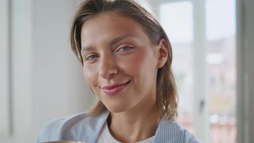 Woman Smiling Gently Indoors, Close Up Portrait