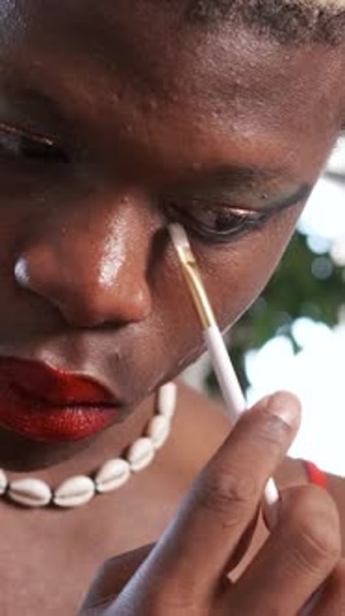 Person Applying Eye Makeup with Brush, Close Up