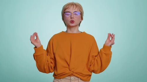 Woman Meditating Indoors on a Light Blue Background