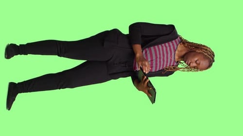 Vertical Video Modern Person Using Digital Tablet on Green Screen Backdrop
