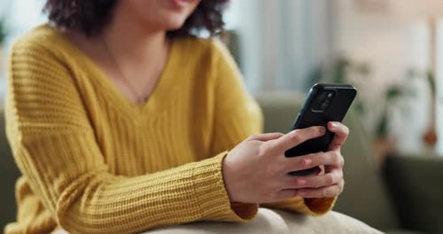 Woman, hands and typing with phone on sofa for online chatting, texting or app at home