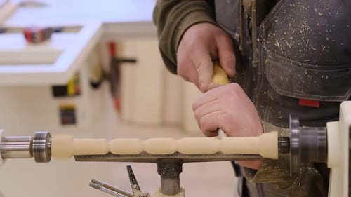 Close Up Carpenter at Workshop Polishes Wooden Board with a Electric Orbital Sander Woodwork and