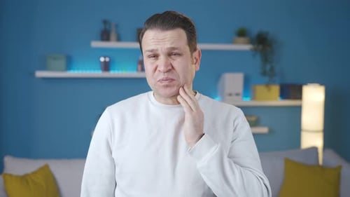 Man suffering from toothache at home. Toothache.