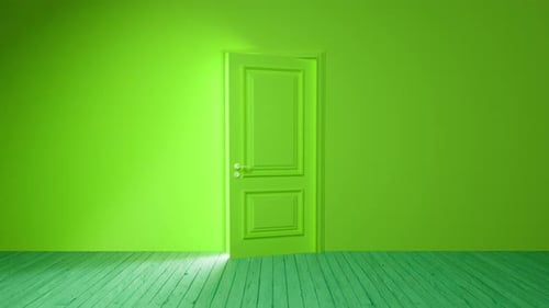 Green door opening to bright light in empty room