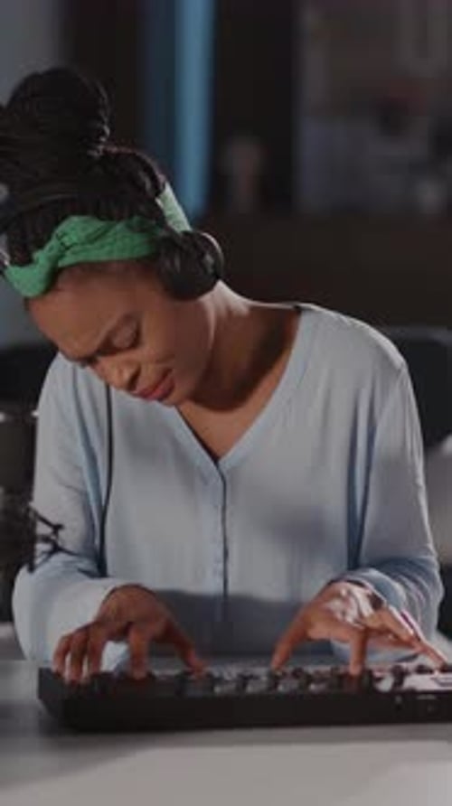 Woman Passionately Playing Keyboard in Studio