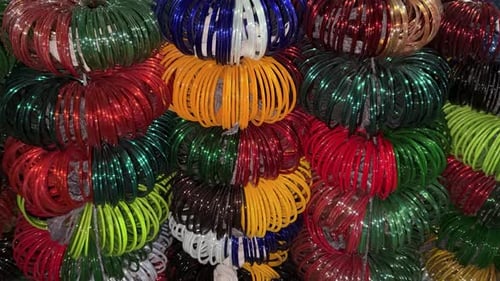 stacked colorful wrist bangles with glossy texture in indian bazaar shop