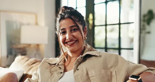 Smiling Woman Relaxing on Couch Indoors