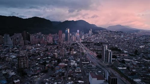 Drone shot of modern city skyline at sunset with mountains in background – Bogotá, Colombia