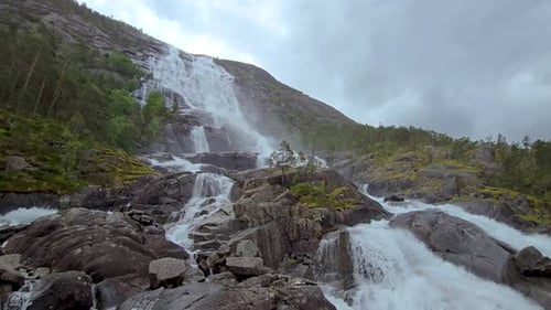 Aerial Video of a Mountain Waterfall with Cascading Water Rocks Trees in Norway