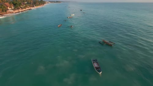 Aerial view of fisher boats on tranquil blue ocean waters. Zanzibar, Tanzania.