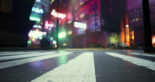 Urban Street at Night with Neon Lights Reflecting on Wet Pavement