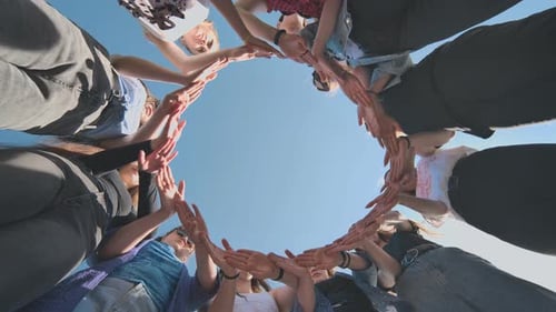 A Group of Girls Makes a Circle From Their Palms