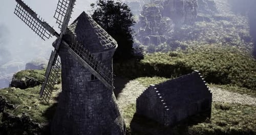 Historical Windmill Stands Majestically on Rocky Landscape During Golden Hour
