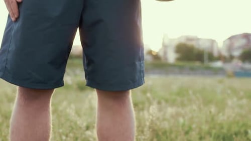 Soccer Player Holding Ball in a Field
