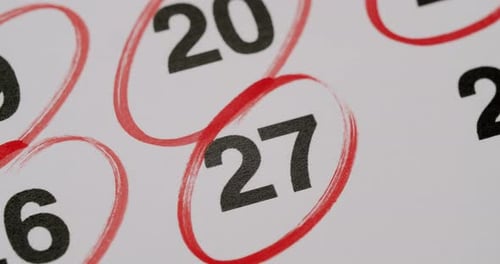 Circling Date on Calendar Page with Red Marker