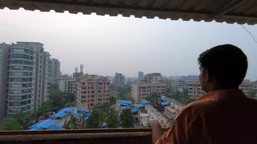 Indian gangster point gun at a man on the building terrace