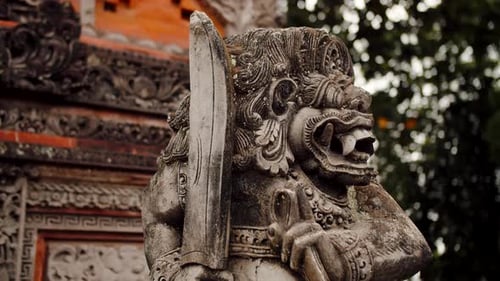 Ancient Stone Statue at Temple Holding Dagger