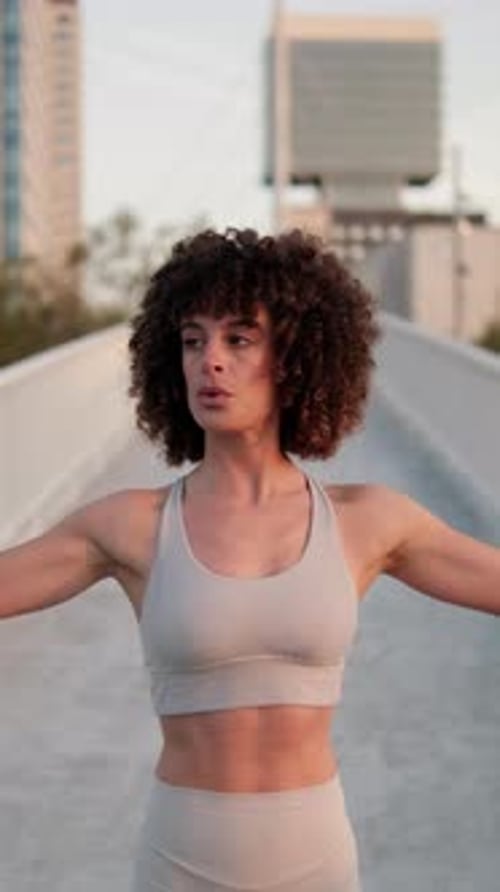 Vertical video, Young Woman Breathing on City Bridge Before Workout