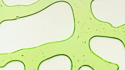 Transparent Green Cosmetic Gel Fluid With Molecule Bubbles and Oil on White Background Macro Shot