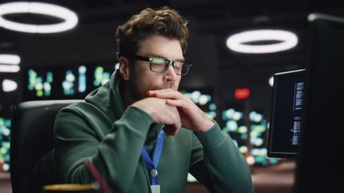 Focused Scripter Looking Computer Typing Keyboard at Night Datacenter Closeup