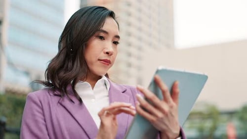 Buildings, business and tablet with Japanese woman outdoor in city for break, email or research