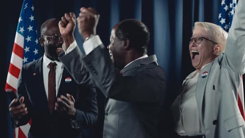 Politicians Celebrate Election Victory with Embrace and Handshake