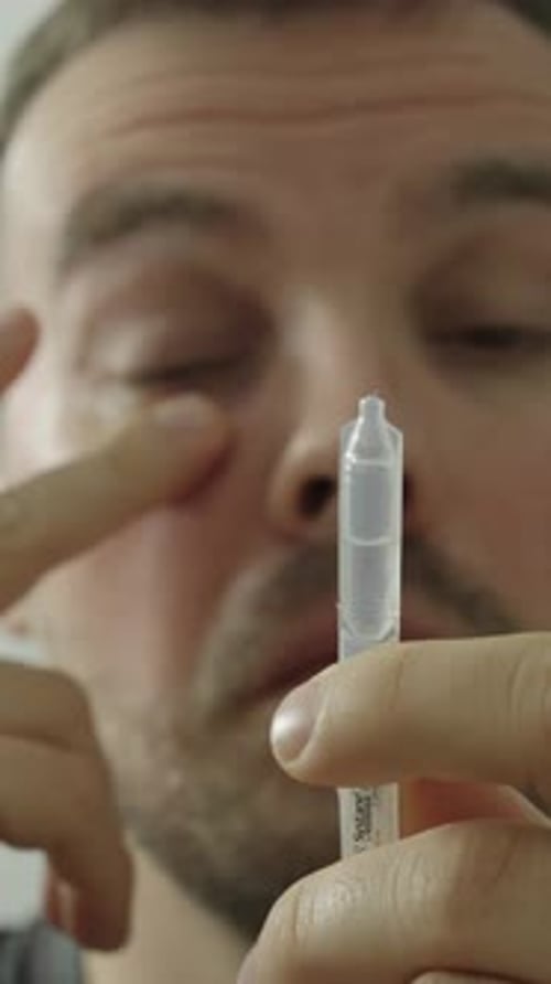 Man using eye drops for dry eyes